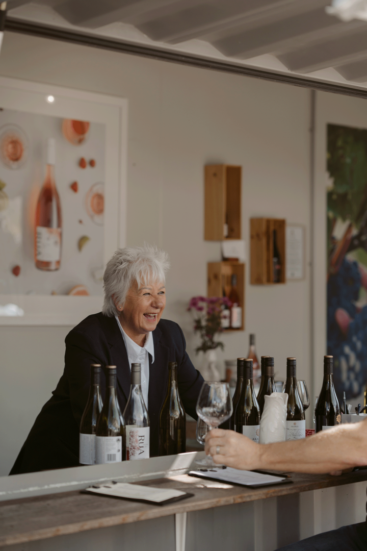 Smiling woman with a collection of wine